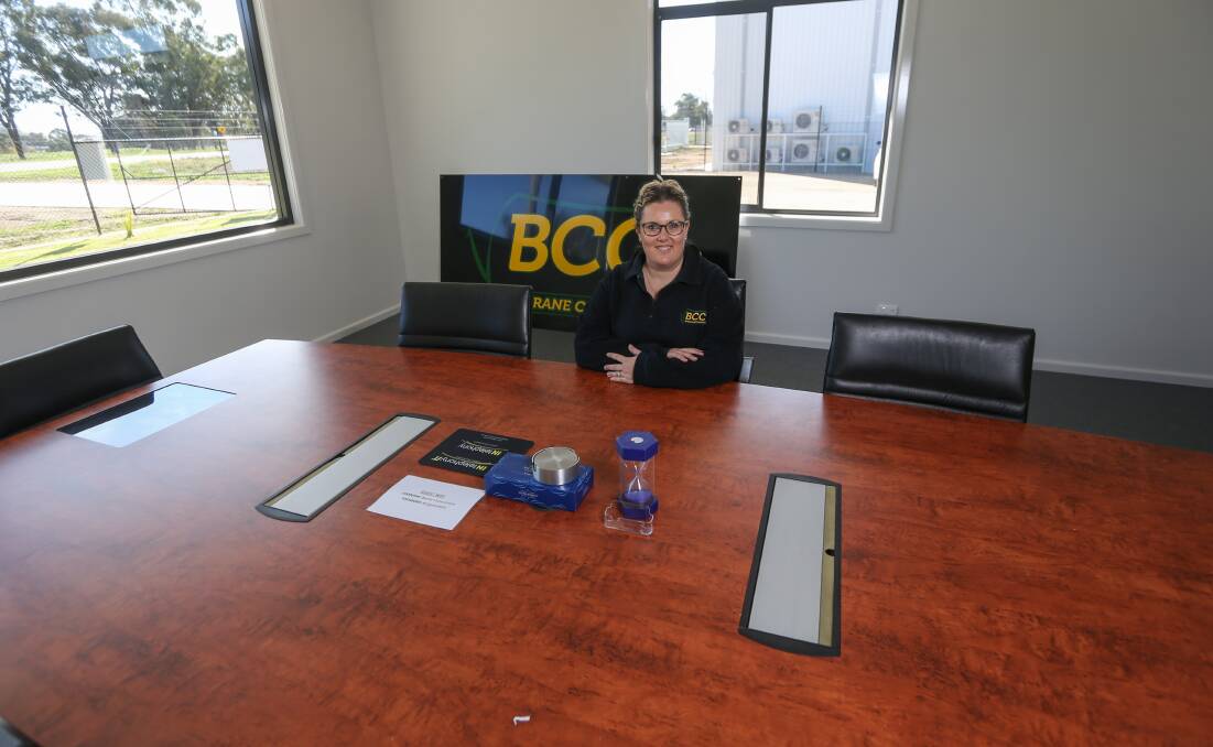 Story behind it: Melissa Barry sits at her company's boardroom table. The piece of furniture was bought from Lavington gearbox factory DSI International. Picture: TARA TREWHELLA