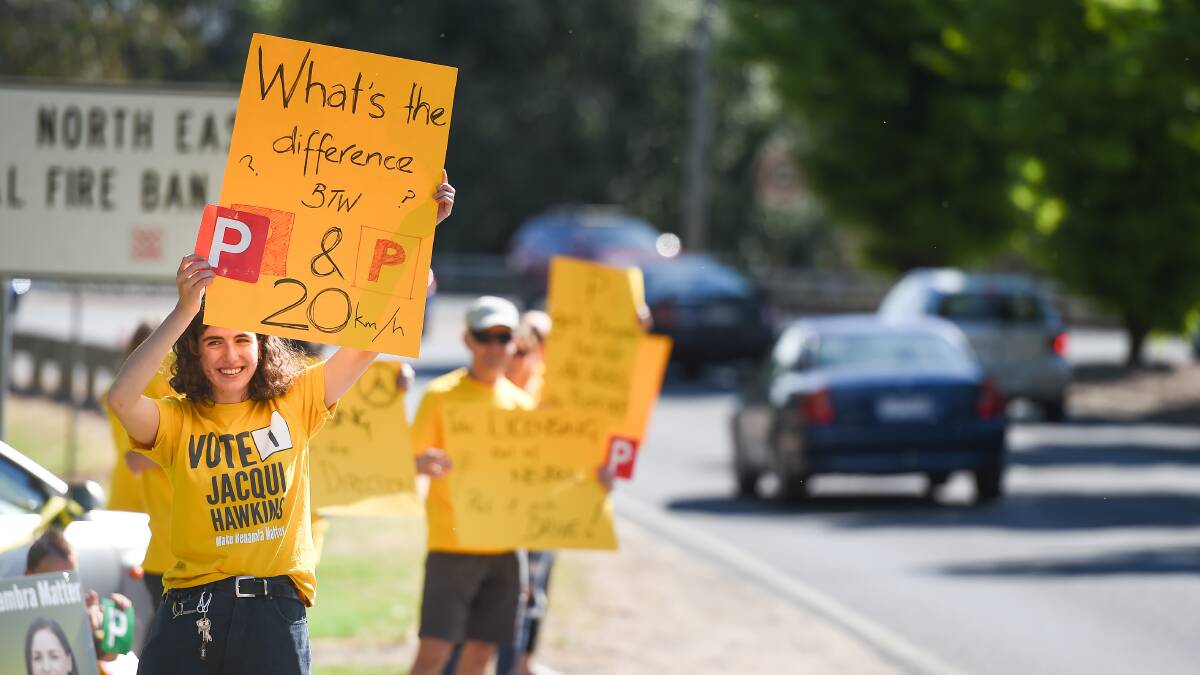 Sign of frustration: Ellie Sidoti underscores different driving rules during a protest that saw placards shown to southbound drivers on the Lincoln Causeway near the Gateway Village in Wodonga. Picture: MARK JESSER