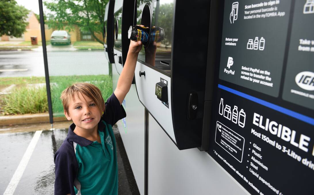 Cashing in: Lavington Public School pupil Ashton Bleakley, 9, puts a can in the reverse vending machine at Springdale Heights on Friday morning. Pictures: MARK JESSER 