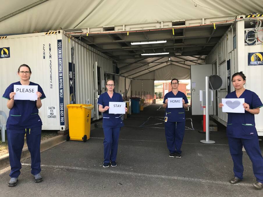 Simple message: Albury Wodonga Health staff working at the coronavirus testing clinic in Wodonga tell citizens what they require of them as COVID-19 cases rise. 