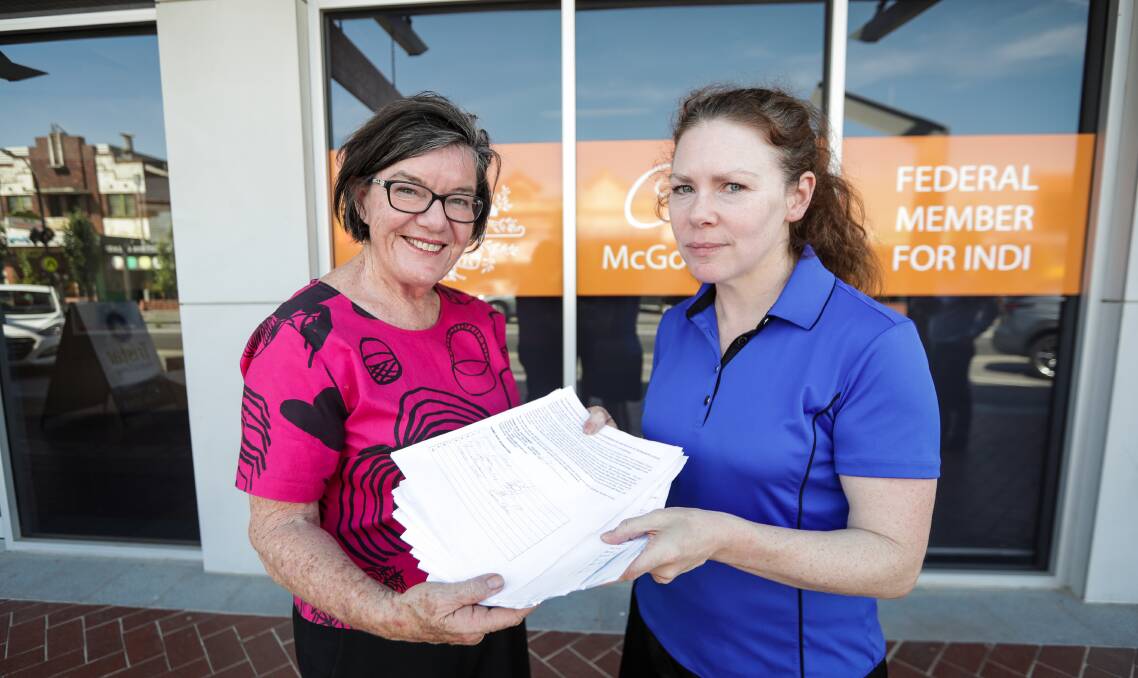 Flashback: Cathy McGowan receives petitions in December from parent Gennifer Hamam in relation to the Bellbridge childcare centre. It will remain open thanks to the intervention of Towong Council. 