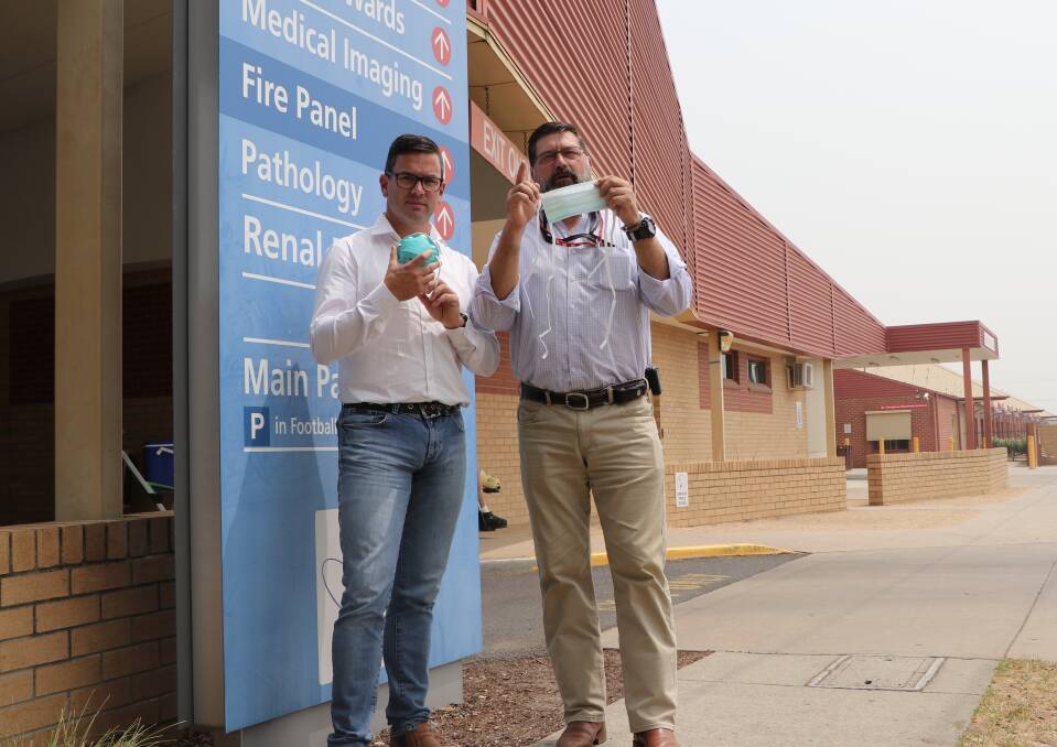 Call for action: Victorian Liberal politicians Brad Battin and Bill Tilley want face masks distributed across the North East. They're pictured at Wodonga hospital with masks that are not the P2 variety. 