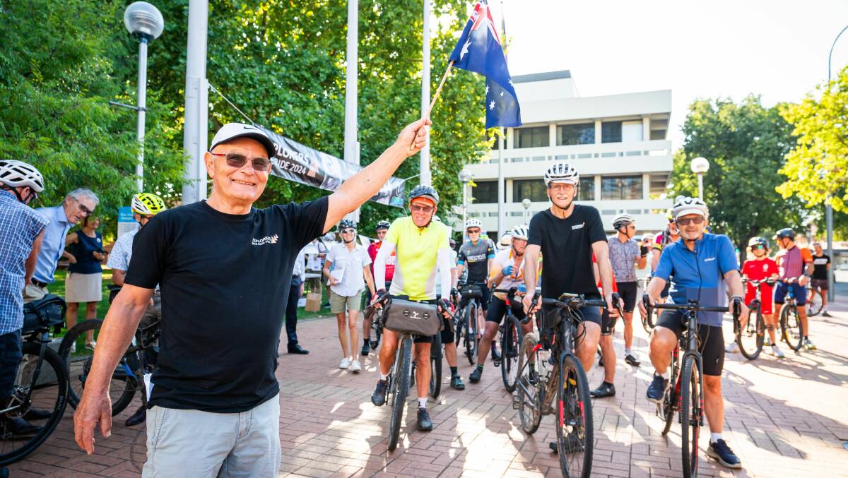 Explorers Bike Ride developer Peter Harper waves off cyclists for a promotional pedal after the bicentennial commemoration was launched in Albury's QEII Square. Picture by Simon Dallinger
