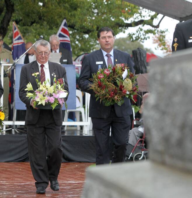 Flashback: Kevyn Williams and Bill Tilley lay wreathes at the Wodonga cenotaph on Anzac Day in 2015.
