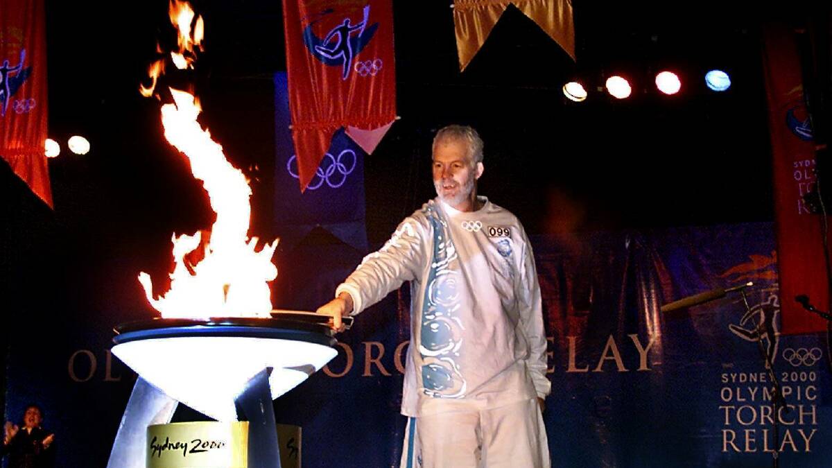 Flames burst forth: Henry Duncan lights up Albury's torch celebration. The cauldron is now in storage.