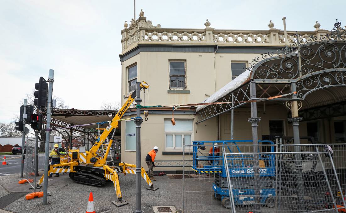 Back in place: The column in front of the crane and the one to the right near the portico were both put in place on Friday by steel fabricators. Picture: JAMES WILTSHIRE