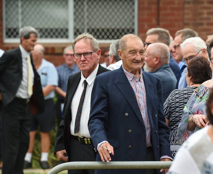 Two old mates: Fred Longmire with Jack Clancy after the funeral of their premiership team-mate John Lane at John Foord Oval at Corowa in February.