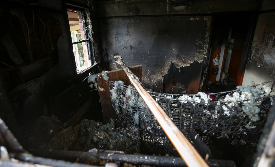 Barely recognisable: The springs of a mattress are exposed after fire ravaged this bedroom in the Mate Street house. Picture: JAMES WILTSHIRE