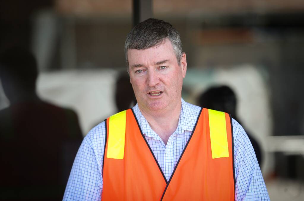 In the spotlight: Cross border commissioner Luke Wilson answers media questions in Wodonga near The Cube building on Tuesday. Picture: JAMES WILTSHIRE