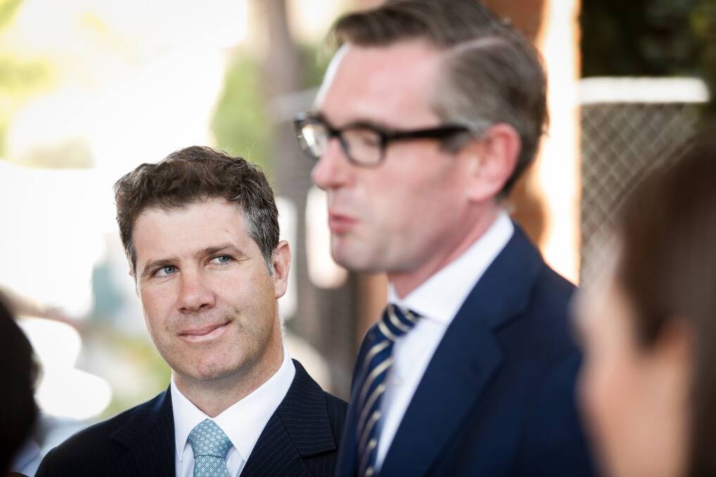 Focussed: Liberal candidate for Albury Justin Clancy listens to NSW Treasurer Dominic Perrottet make a point during a media conference on Wednesday. Picture: JAMES WILTSHIRE