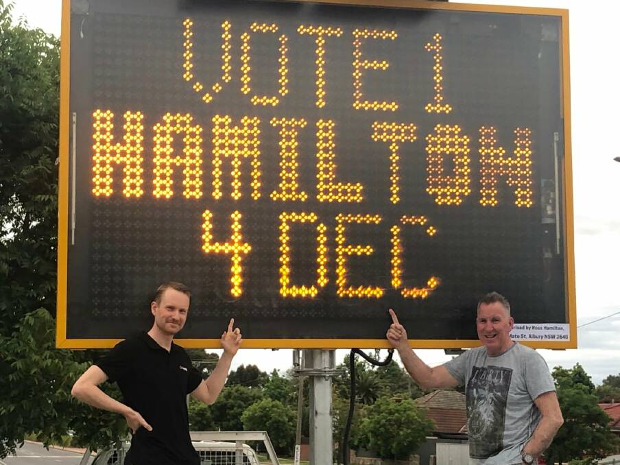 Showing his support: Albury mayor Kevin Mack joins Ross Hamilton with his message board for a photograph that has been uploaded to the Team Hamilton Facebook page.