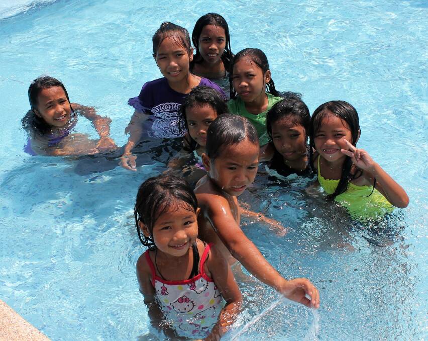 Haunting image: A picture Michelle Michael took of her three nieces, Lea, Lycil and Princess, swimming with friends and relatives in a toddlers' pool in the Philippines. 