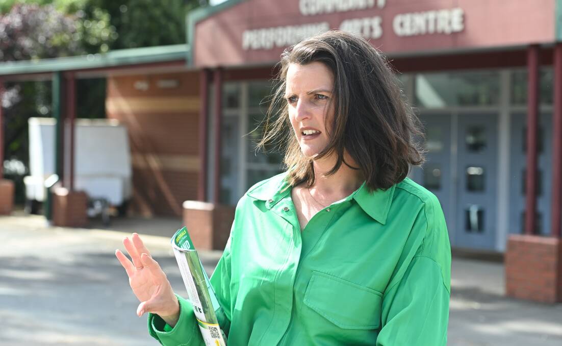 Nationals candidate Annabelle Cleeland makes a point as she hands out how-to-vote cards at Benalla on Saturday afternoon. Picture by Mark Jesser.