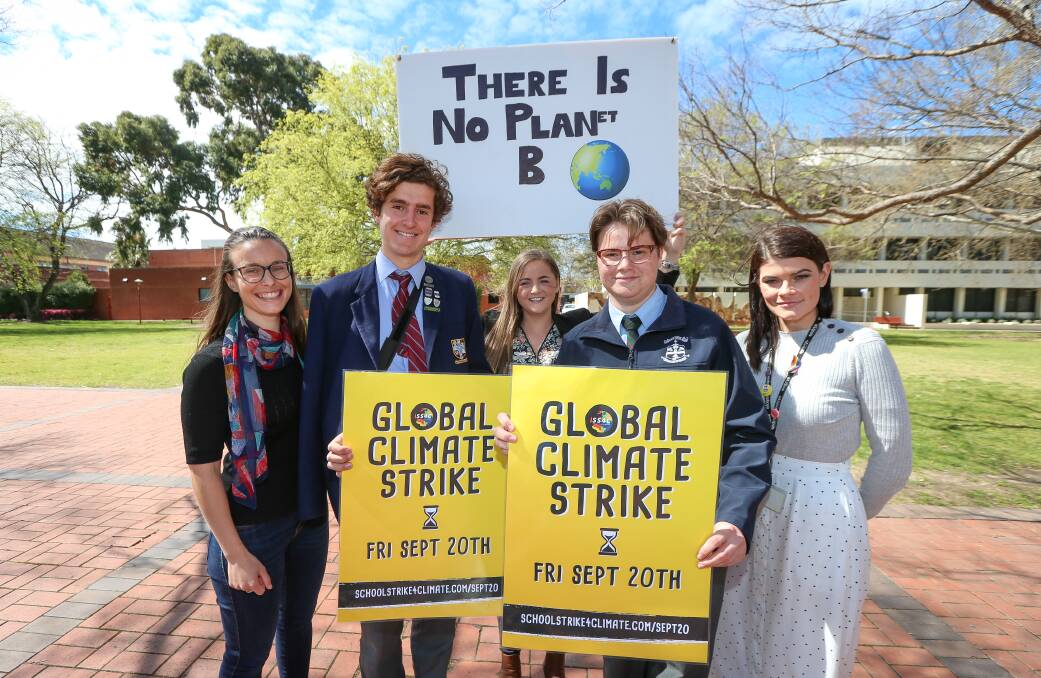 Flashback: Albury deputy mayor Amanda Cohn (left) last year before a climate change rally. She lost a bid on Monday night to have her council accept the world is in a climate emergency. Eli Davern (second from right) urged the council to support the wording.