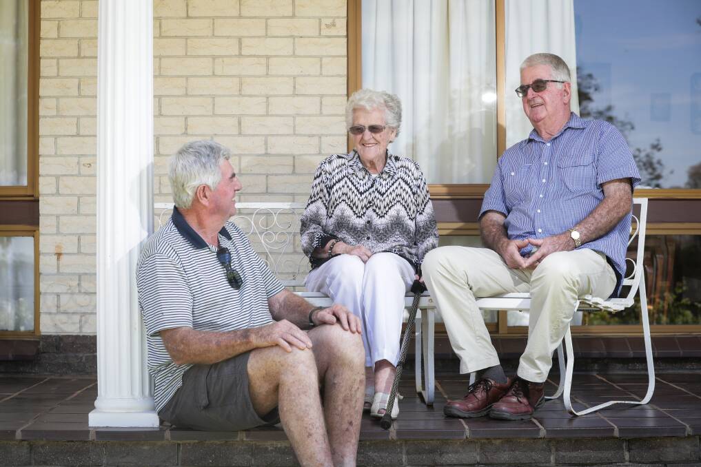 Well done: Sons Ken and Geoff look on in admiration at their mother Aylean Baker. Picture: JAMES WILTSHIRE 