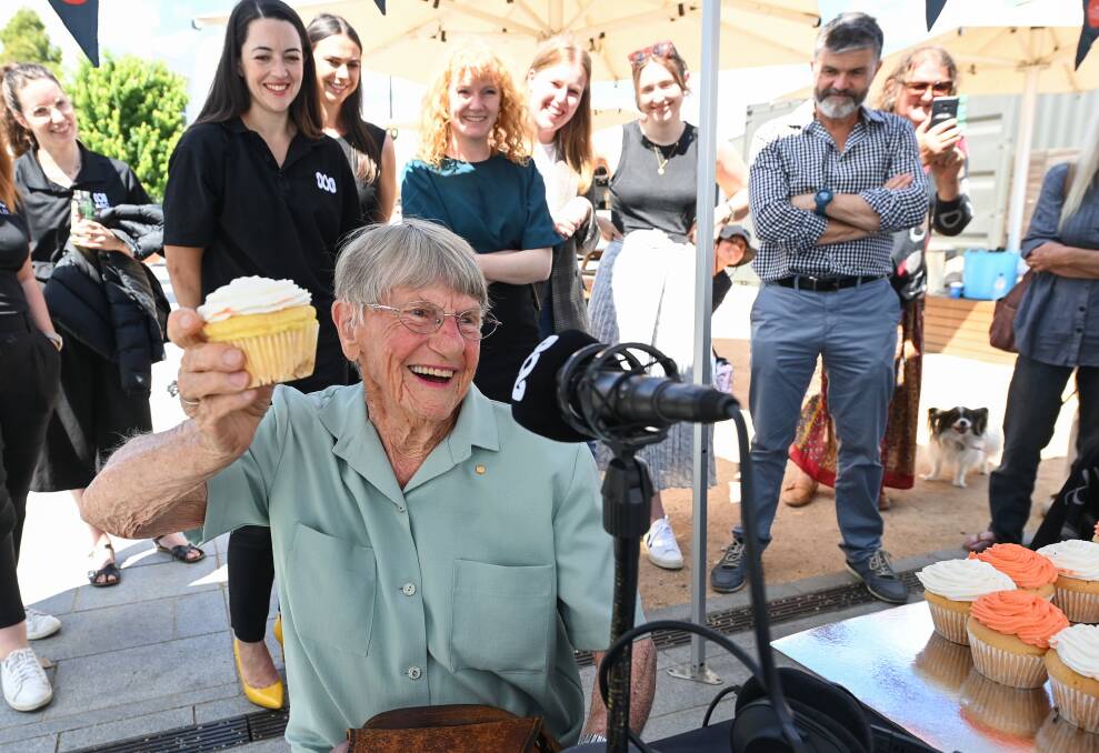 Icing on top: Jean Whitla salutes ABC Goulburn Murray. Among those watching were journalists Erin Somerville, Mikaela Ortolan and Katherine Smyrk and Shepparton breakfast host Matt Dowling. Picture: MARK JESSER