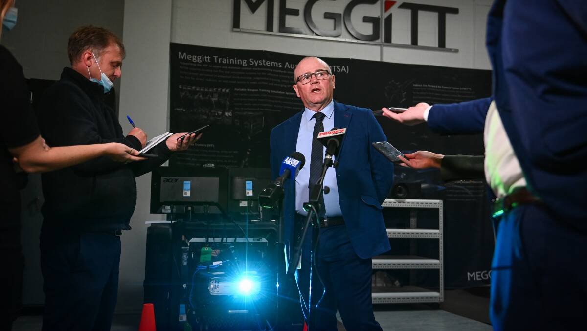 Outlining: InVeris Training Solutions managing director Kevin McNaughton speaks to the media on Monday morning about his mobile weapons simulation units. The blue light is being beamed out from equipment used to set up artificial targets. Picture: MARK JESSER