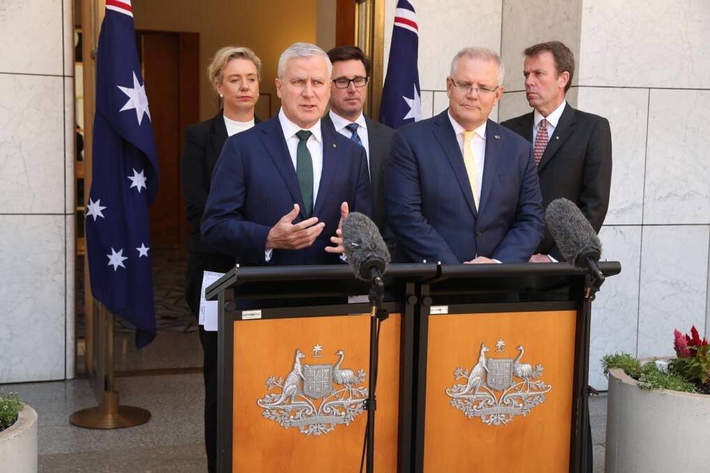 Offering help: Deputy Prime Minister Michael McCormack and Prime Minister Scott Morrison at the lecterns addressing the media in Canberra. Watching over them are Agriculture Minister Bridget McKenzie, Water Resources and Drought Minister David Littleproud and Education Minister Dan Tehan. 