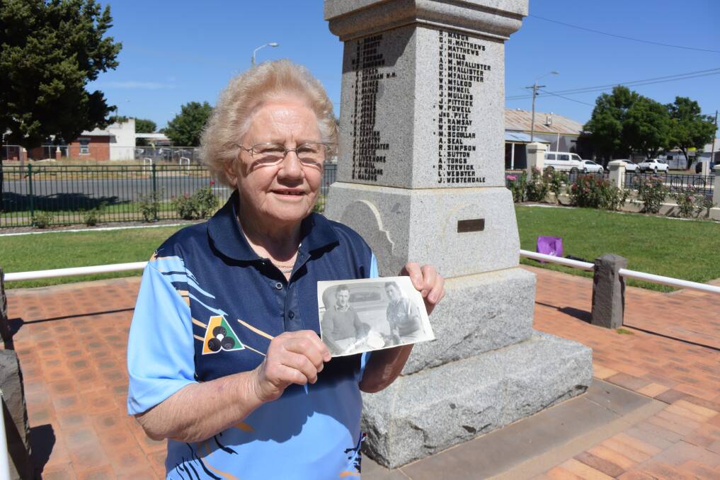 Childhood memories: Lola Wilson in front of Finley's war memorial with a photograph of her Jack Horneman and fellow Finley soldier Thomas Jarratt taking a break from army training at Bonegilla. Private Jarratt also died in New Guinea in January 1942.