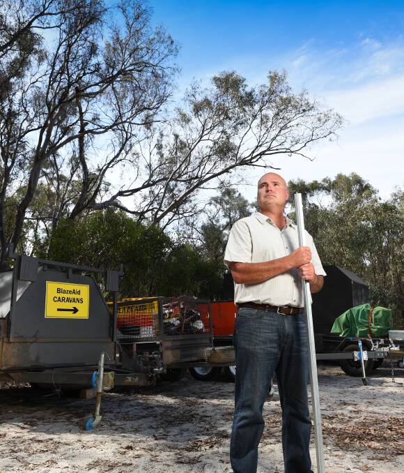 Tools of the trade: Indigo councillor Emmerick Teissl with BlazeAid trailers brought to Barnawartha to help remove and repair fences damaged by fire in the Indigo Valley. Picture: MARK JESSER