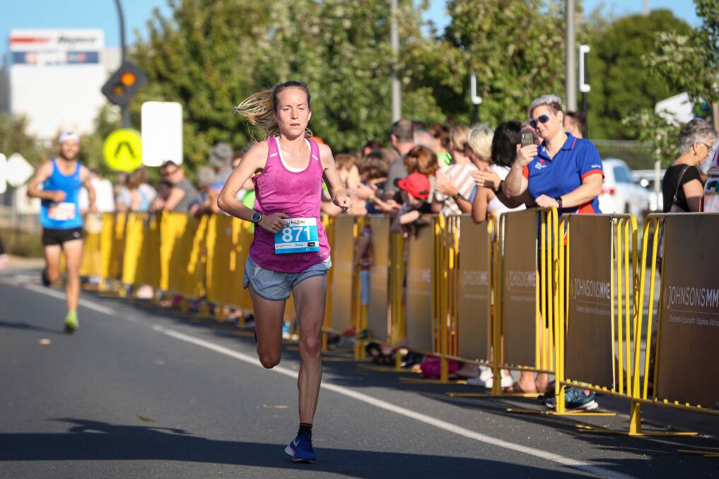 Well in stride: Charlotte Wilson heads for the finishing line along Wodonga's Elgin Boulevard to claim first place in the women's 15-kilometre race. 