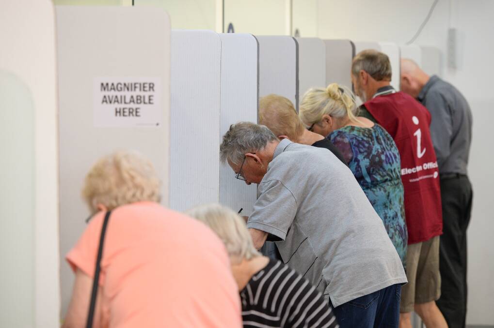 Join the crowd: Some of the huge number of voters who have already cast their ballot in the seat of Benambra at the Wodonga prepolling centre in High Street. Picture: MARK JESSER