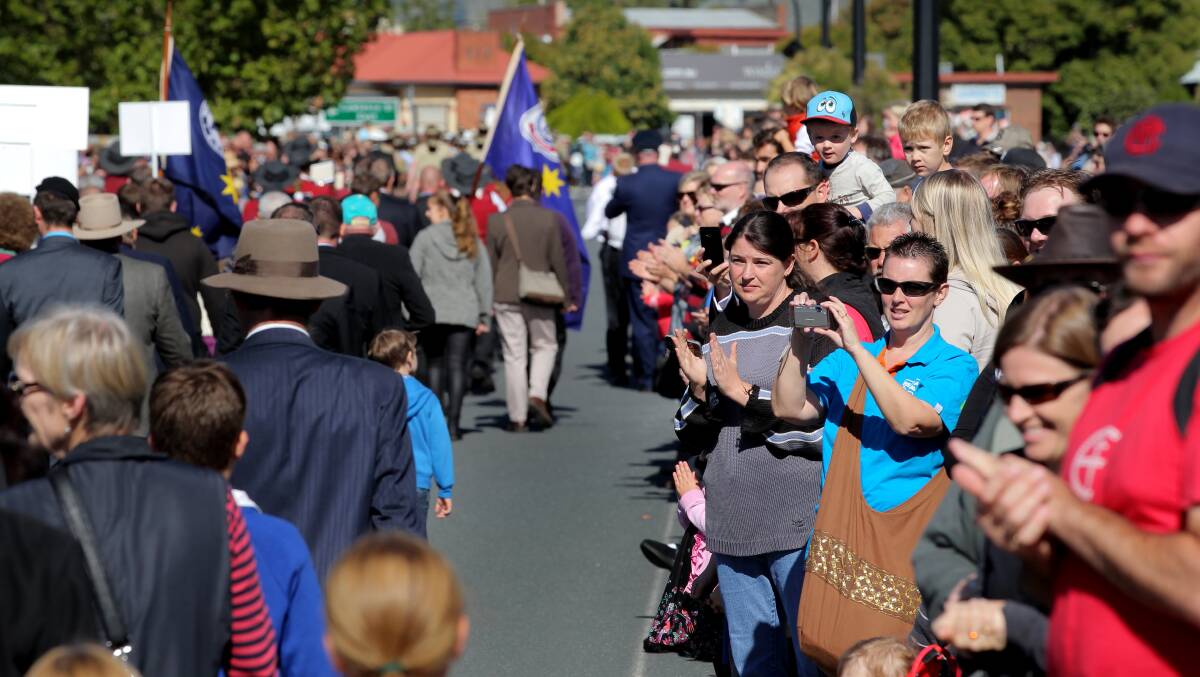 Flashback: Onlookers applaud as returned service personnel and families march along Havelock Street when High Street was out of action in 2014.