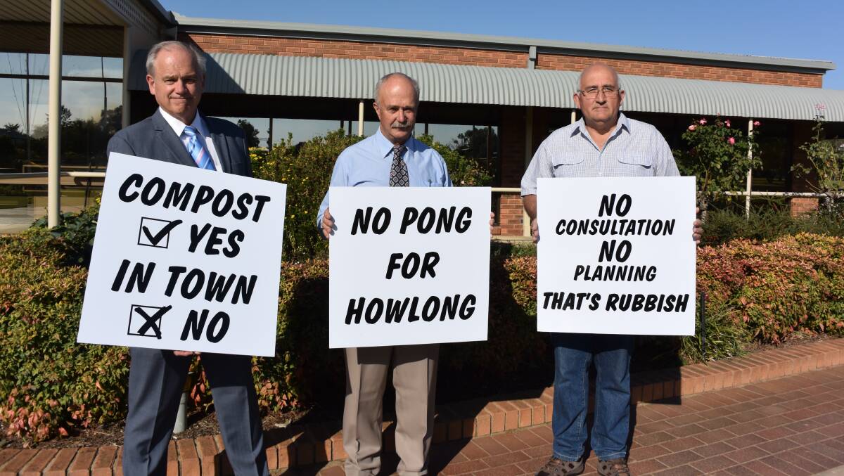 Writing's on the signs: Anti-composting site campaigners Mark Shields, Stuart Sizer and Brian Hardidge with placards which will be displayed around Howlong.