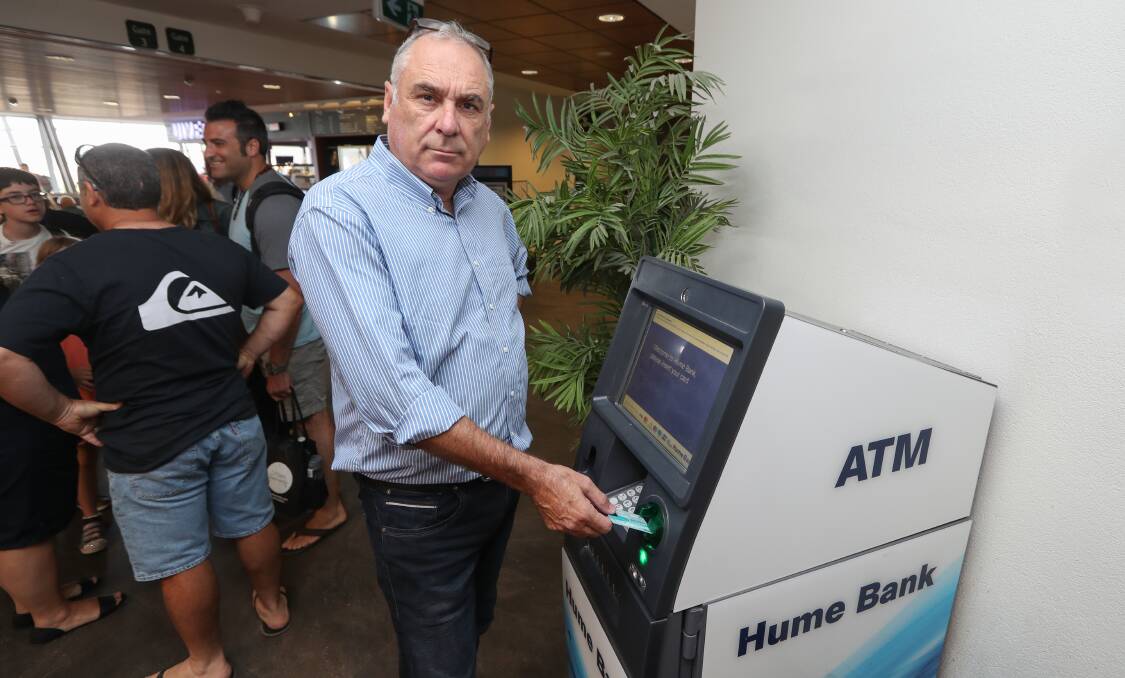 Fee-ling annoyed: Albury councillor Murray King with the automatic teller machine at his city's airport. He believes it is not fair it has a $3 charge for non-Hume Bank members. Picture: MARK JESSER