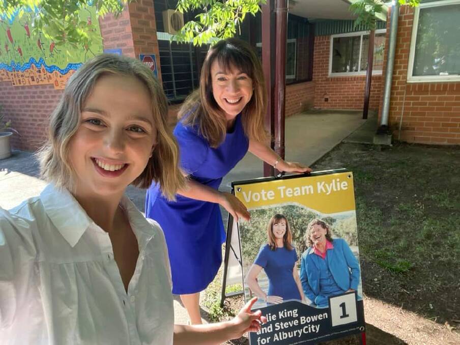 Top of the polls: Successful election candidate Kylie King holds her sandwich board, while her ticket No.5 Taneesha Smith takes the photograph. Source: FACEBOOK