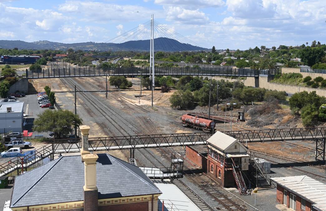 The pedestrian bridge in the foreground is set to be replaced to allow double-stacked trains to pass through like they already can under the Harold Mair Bridge to the north. Picture by Mark Jesser
