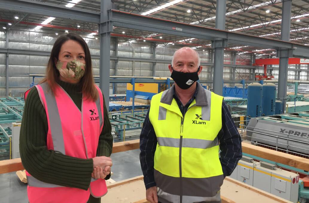 Above the factory floor: Jaclyn Symes and Anthony Quinnell stand on a viewing platform at the XLam factory at the Logic industrial estate.