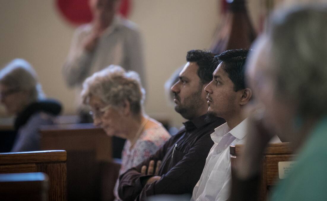 Faces in the congregation: Muslims Mohammad Hussain and Syed Qadri, who emigrated to Australia from India, listen to the service at St Matthew's on Sunday. Picture: JAMES WILTSHIRE 