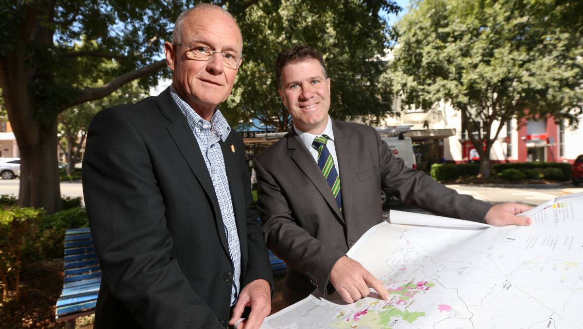 On the map: Phil Clements and Justin Clancy with a map showing the log-haulage routes which will receive government funding. Picture: JAMES WILTSHIRE