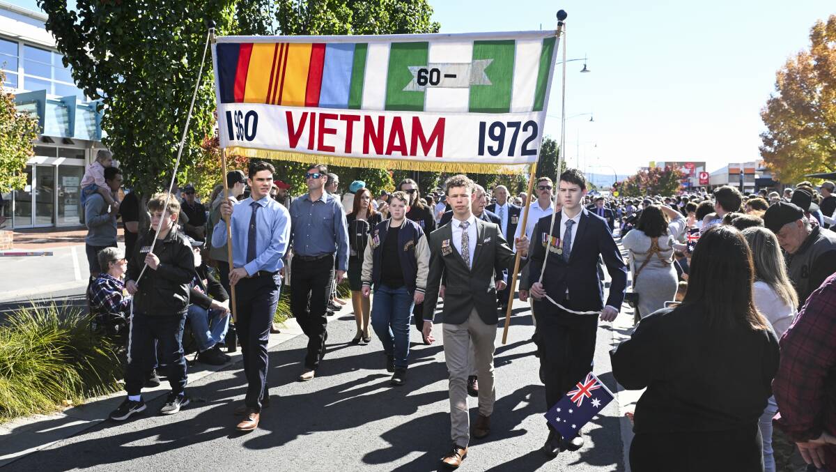 The historic Albury banner is held up at the head of the group of Vietnam War veterans and their relatives who marched in Wodonga's Anzac Day parade. Picture by Mark Jesser