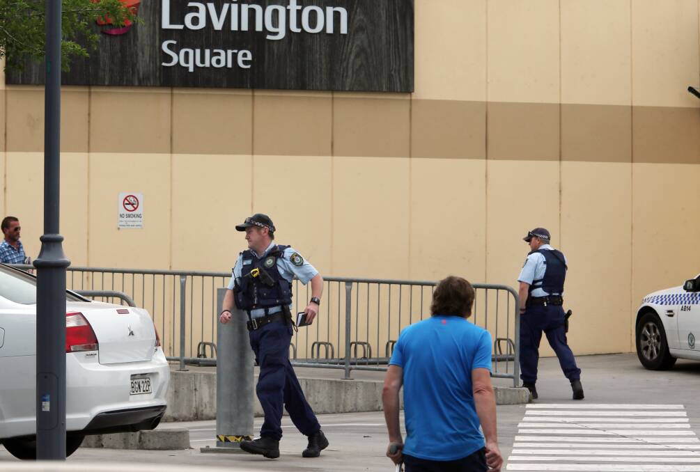 Flashback: Police swarm around Lavington Square as part of a hunt for bag snatchers in 2014.