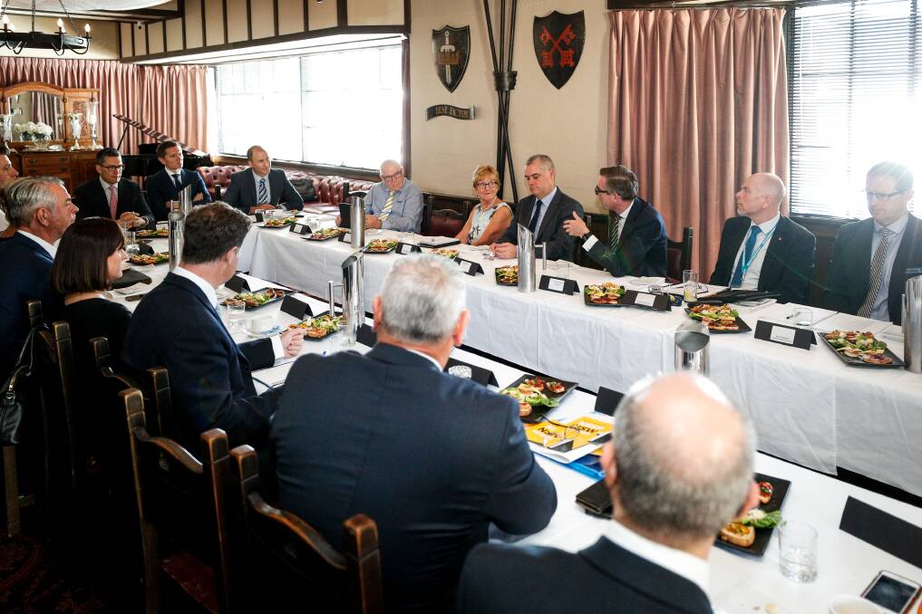 Forum: NSW Treasurer Dominic Perrottet (on the window side of the table with his hand up) makes a point during his meeting with business, council and community representatives on Wednesday at the Albury Manor House motel. Picture: JAMES WILTSHIRE