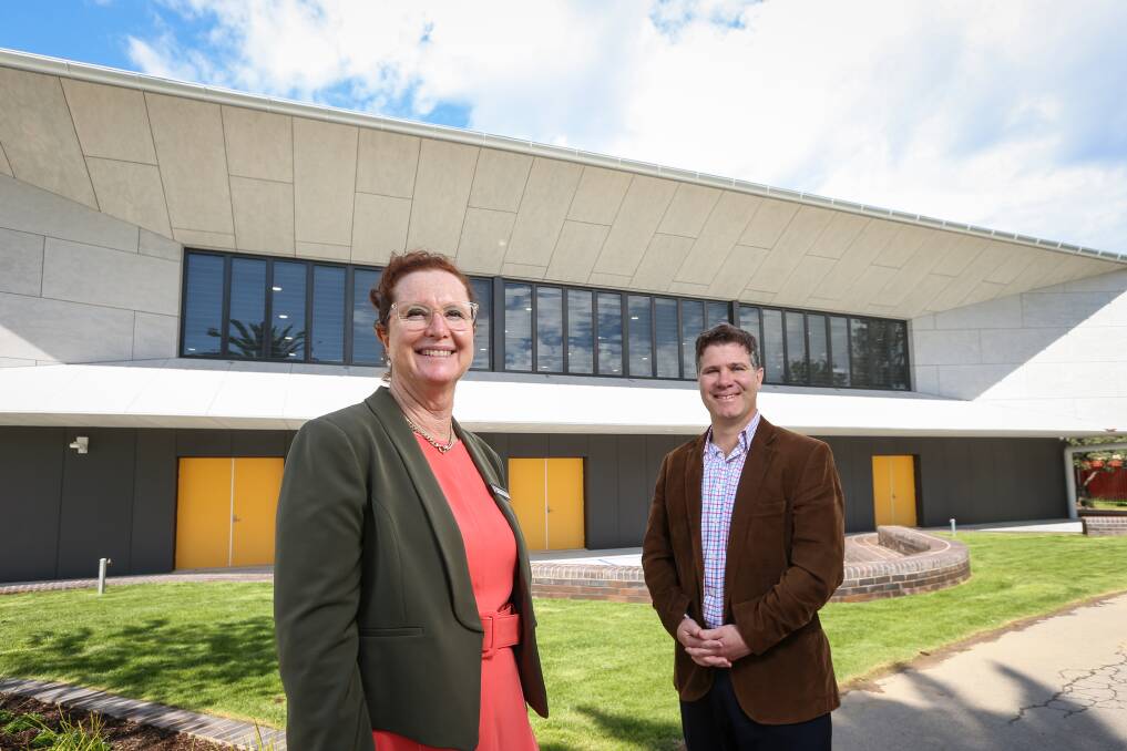 It's complete: James Fallon High School principal Jenny Parrett and member for Albury Justin Clancy on the northern side of the new hall which looks over sporting areas. Picture: JAMES WILTSHIRE