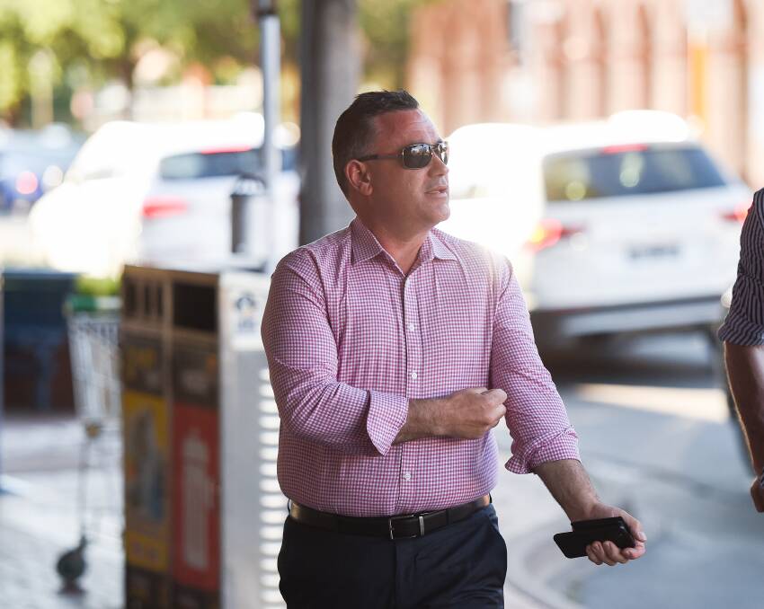 Careful eye: Deputy Premier John Barilaro looks over to the median strip in Dean Street, Albury, when protesters from IGA supermarkets made their dissatisfaction with the container deposit scheme known to the NSW Cabinet.