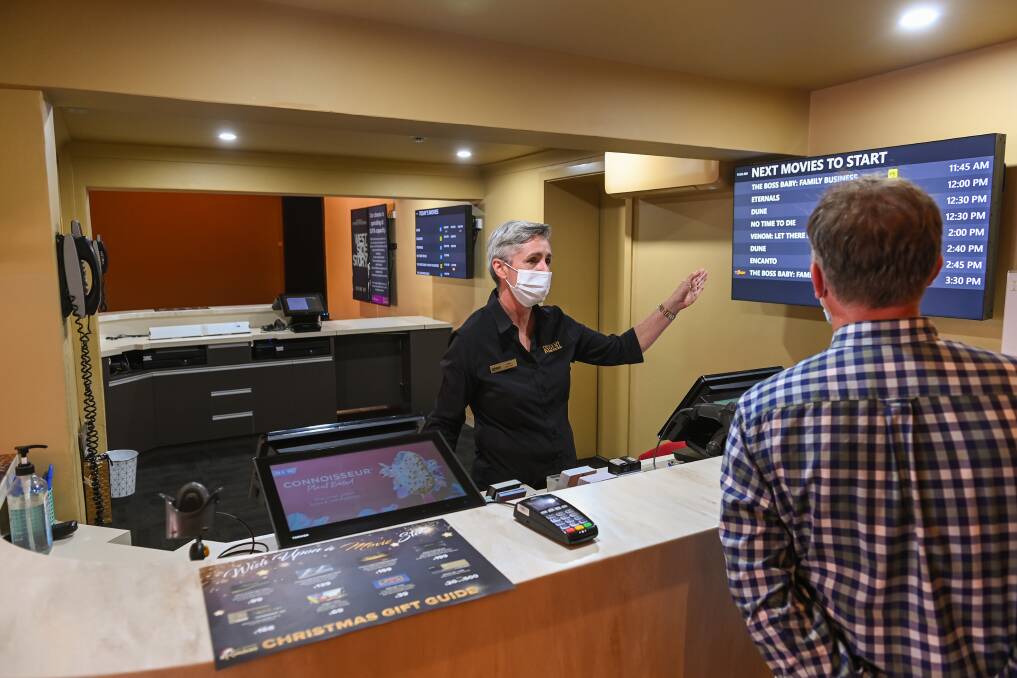 New spot: Ticket seller Jodie Goss points to film listings in the new box office. Pictures: MARK JESSER