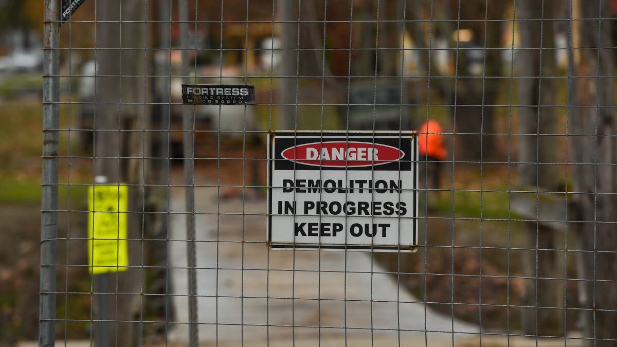 Closed zone: Fencing has been erected around the timber suspension bridge across Wodonga's House Creek while it is being demolished. 