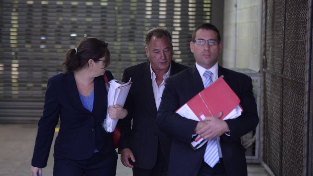 Downfall: Jeremy Kewley (centre) after receiving bail on 103 charges in December 2014. They were later reduced to 19 charges and the actor was sentenced to 23 months jail in 2016.