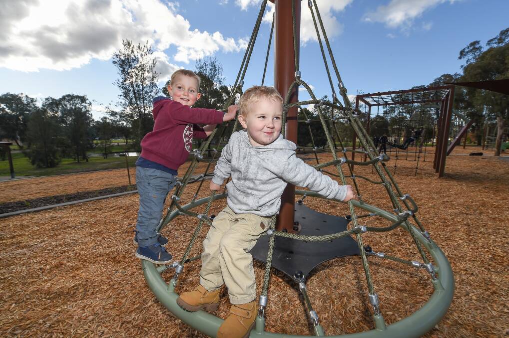 In the swing: Archer Edmondson, 2 and Kane Piper, 3 of Lavington, enjoy the new playground equipment at Lavington's Foresters Grove. Picture: MARK JESSER