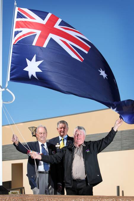 Flashback: Peard's owner George Benyon with Captain Borella's son Rowan Chalmers Borella and Albury councillor and RSL representative Graham Docksey at a national flag event at the nursery in 2014.