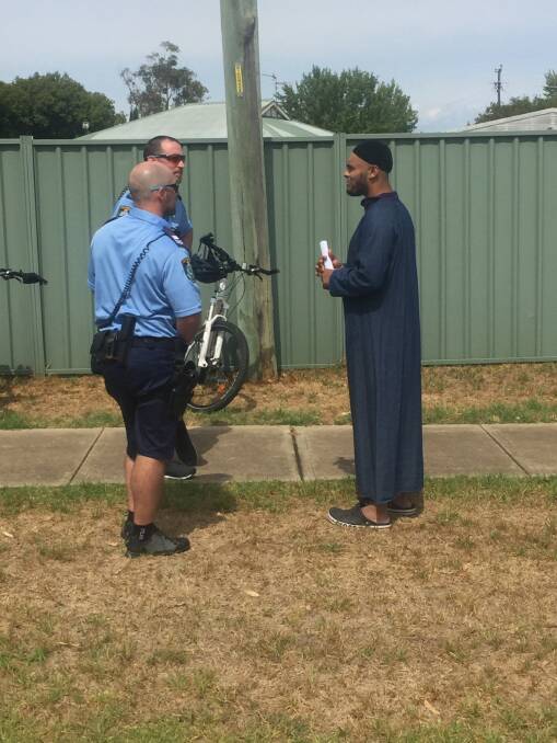Peace of mind: Police are thanked for standing guard outside the Wagga Road mosque during Friday's prayers.