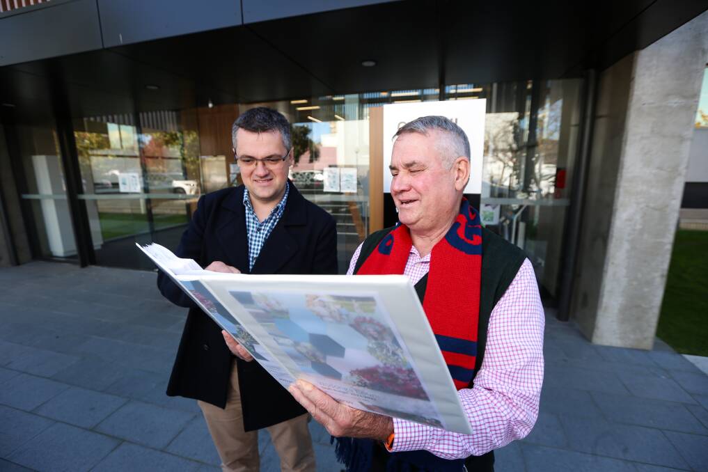Flashback: Wodonga councillors Kev Poulton and John Watson pore over the city budget last month which presented a large surplus for the municipality.