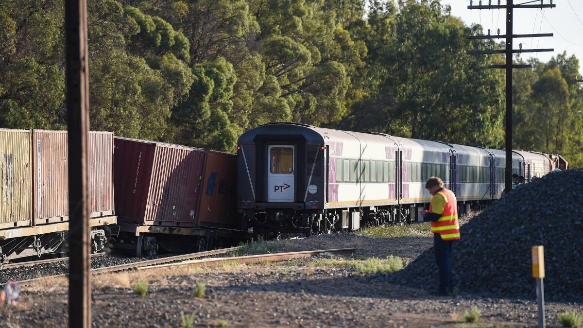 Too close: The goods train leans into the rear of the passenger train after derailing south of Barnawartha's main crossing. Picture: MARK JESSER 