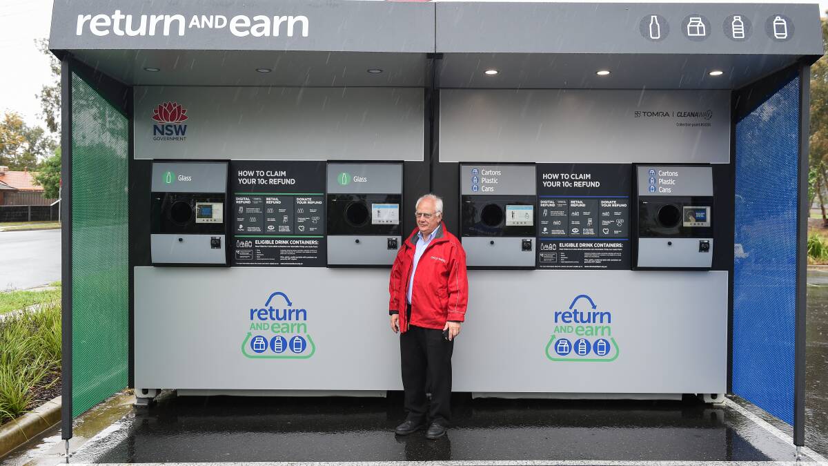 Ready for the returns: Bob Mathews at the reverse vending machine which began operating on Friday. The unit has been criticised for not having holes low enough for wheelchair-bound users. The EPA has said changes will be made, but won't say what they will involve.