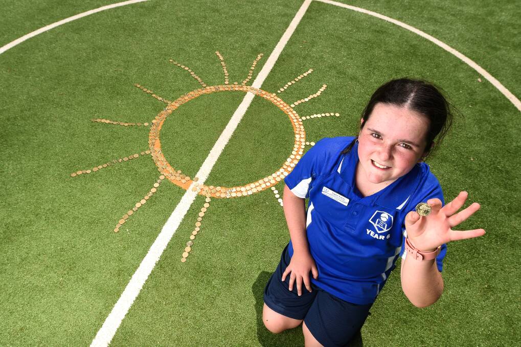 Fund-rayser: Taylor Furze with the sun shape formed by Thurgoona Public School pupils to help generate cash for the Albury Wodonga Regional Cancer Centre. Picture: MARK JESSER
