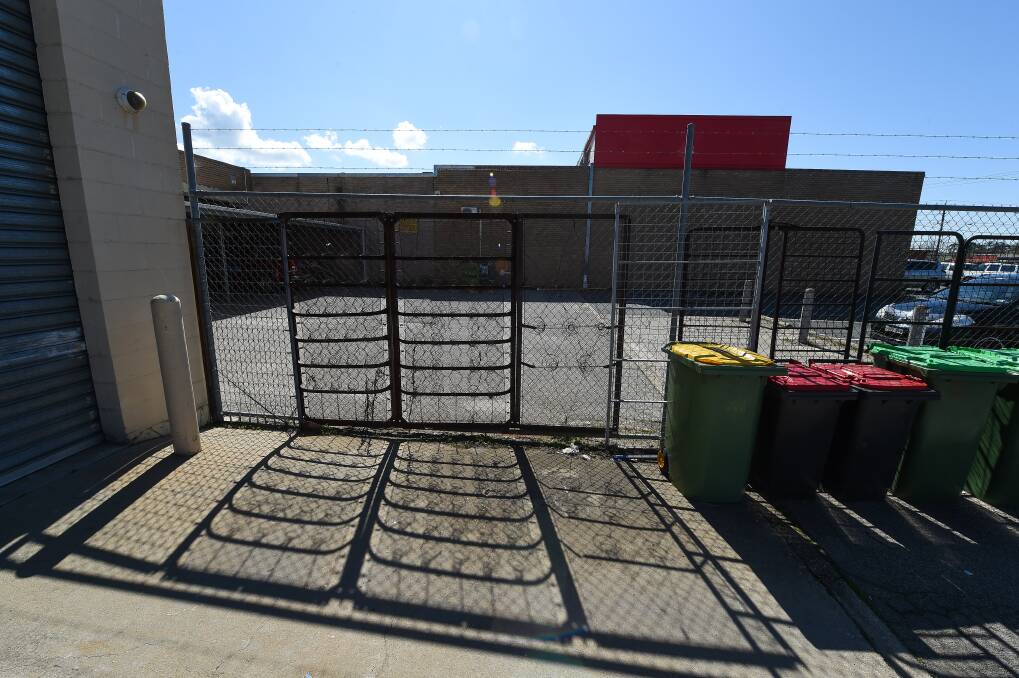 Makeshift: Old bed frames line the side of the wire fence at the rear of the Salvation Army's op shop in Mate Street, North Albury. Picture: MARK JESSER